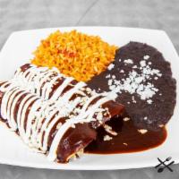Mole Enchiladas (2) · Mexican rice, refried black beans, sour cream, queso fresco, corn tortilla, sweet mole