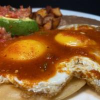 Huevos Rancheros Plate · 2 eggs on top of grilled corn tortillas with ranchera sauce on top.served with refried beans...
