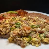 Machaca Plate · Scrambled eggs, serranos, tomatoes, onions and carnitas meat (braised lean pork) served with...