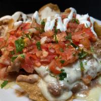 Regular Nachos · Homemade corn chips with melted Monterey jack cheese, mashed beans, salsa fresca and sour cr...