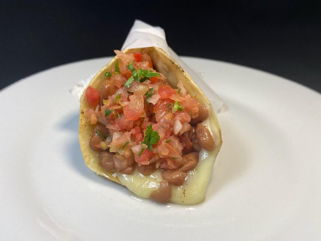 Regular Veggie Taco · Whole pinto beans in 2 corn tortillas with melted cheese and salsa fresca.