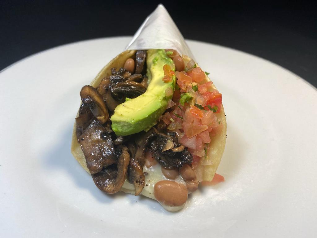 Super Veggie Taco · Fresh sauteed mushrooms in 2 corn tortillas, with melted cheese, whole beans, salsa fresca & avocado.