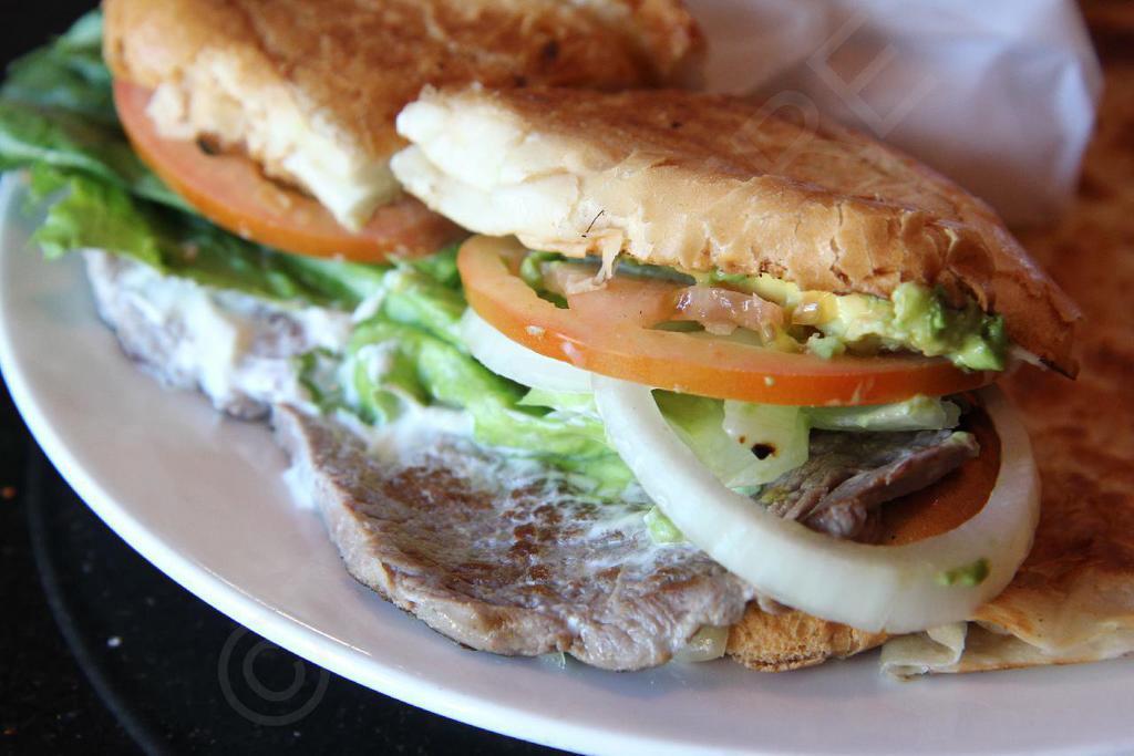 Torta with Steak · Served with mayonnaise, sour cream, cheese, lettuce, tomato, onion and avocado.