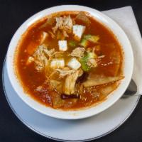 Tortilla soup with Chicken · Chicken with fried pieces of corn tortilla in a chicken & tomato broth topped with avocado, ...