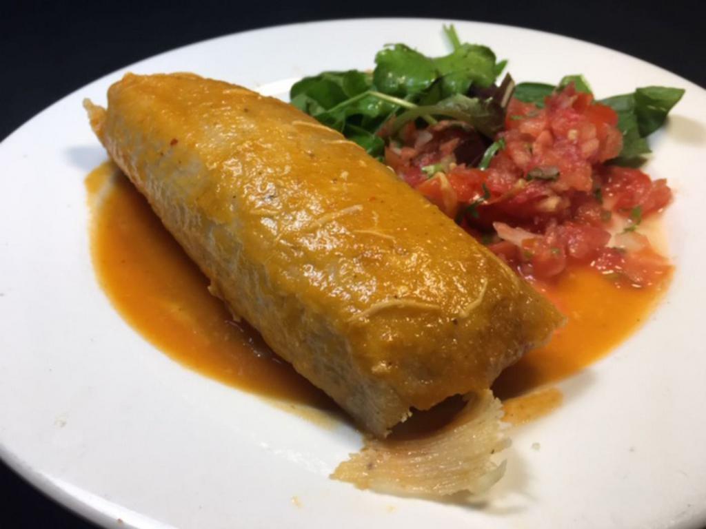 One Tamale · Homemade corn dough tamale made with Chicken, pork or veggies served with a  small salad.
