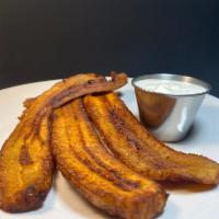 Fried Plantain · A whole plantain served with sour cream on the side.