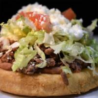 2 Sopes · 2 corn dough fried with your meat choice, mashed beans, lettuce, tomatoes, guacamole, sour c...