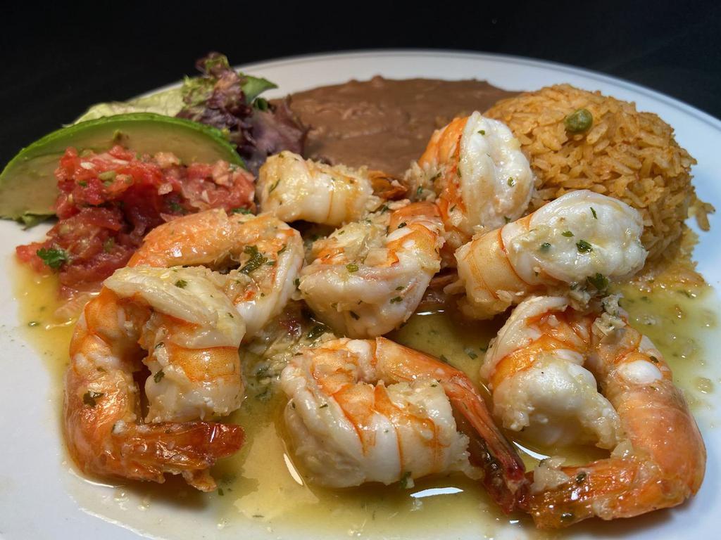 Camarones al Mojo de Ajo · Large sauteed prawns in fresh garlic sauce served with refried beans, Mexican rice, salad & avocado slice. Your choice of  4 corn or 3 flour tortillas.