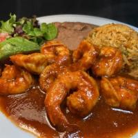 Camarones a la Diabla · Large sauteed prawns in hot spicy sauce served with refried beans, Mexican rice, salad & avo...