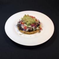 Vegan Tostada · 1 in 2 corn crispy tostadas with sautéed mushrooms, mashed black beans, tomatoes, lettuce an...