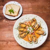 Mejillones al Chipotle · Fresh mussels sauteed in white wine, butter, and our housemade chipotle sauce. Served with t...