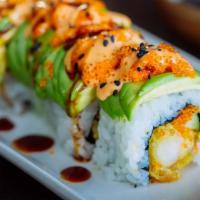 Dragon Roll · Grilled eel, cucumber, topped with sliced avocado & eel sauce and tobiko on top.