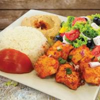 Chicken Kebab Platter · Juicy chicken kebab served on a bed of rice with fresh salad and creamy hummus.
