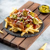 Donermite Fries · Our fries with BBQ meat, a blend of garlic herb sauce and spicy chili sauce, and jalapenos.