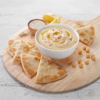 Traditional Hummus Bowl · Traditional hummus, olive oil and a gyro pita bread.