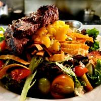 Gluten Free Caribbean Steak Salad · Marinated 6 oz steak grilled medium, mango salsa, pepper jack cheese, tortilla strips and ba...