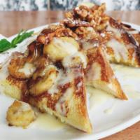 Caramelized Banana French Toast · Our brioche dipped in a rich egg batter, then grilled to golden perfection. Topped with cara...
