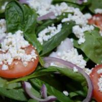 46. Greek Salad · Carrot, red cabbage, cucumber on a bed of lettuce, all topped with feta cheese, marinated pe...