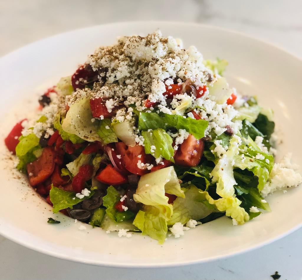 Greek Salad · Romain lettuce, tomato, cucumbers, red onion and Kalamata olive, tossed in olive oil and lemon juice dressing. Topped with feta cheese and zaatar.
