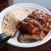 Baby Back Ribs · Served with a small Cole slaw and toasted pita bread. Additional sauce upon request. 