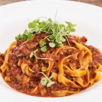Fettuccine alla Bolognese · Homemade pasta with traditional meat sauce. 