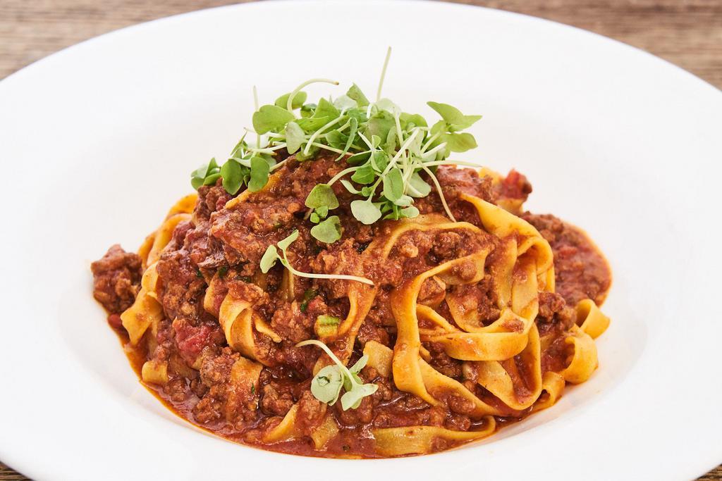 Fettuccine alla Bolognese · Homemade pasta with traditional meat sauce. 