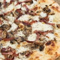 Pizza Tartufo · Black truffle pesto, mozzarella, mushrooms, speck.