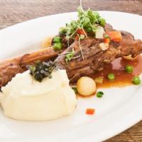 Stinco d'Agnello · Herb roasted lamb shank, pearl onions, mashed potatoes.