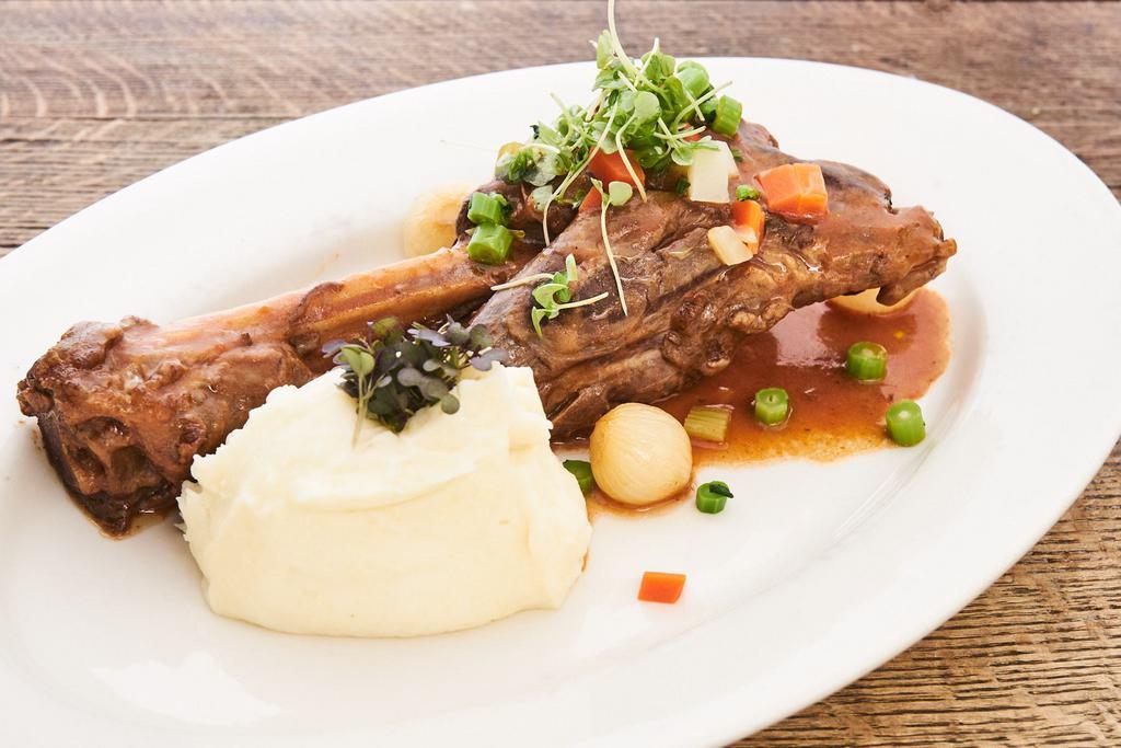 Stinco d'Agnello · Herb roasted lamb shank, pearl onions, mashed potatoes.