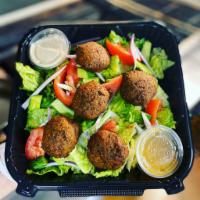 Falafel Salad · it is a garden salad comes with 5 falafel , tahini sauce, hummus 