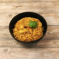 Chicken Biryani · Cubes of chicken cooked with rice and spices. Served with raita (spiced yogurt).