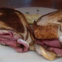 Grilled Reuben · Corned beef, Swiss cheese, sauerkraut, 1000 Island dressing on grilled rye. served with side...