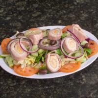 Chef's Salad · Lettuce, tomatoes, cucumbers, red onions, turkey, ham and cheese tossed with house dressing.