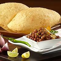 Chole Bhatura · Deep fried puff bread served with chickpea masala portion.