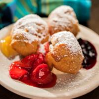 Mardi Gras Beignets · Ben yays. Our signature southern fritters atop sweet, vanilla cream filling with huckleberry...