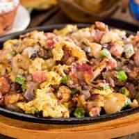 The Mississippi Skillet · Ham, crisp bacon, sausage, bell peppers, onions and mushrooms topped with Monterey Jack chee...