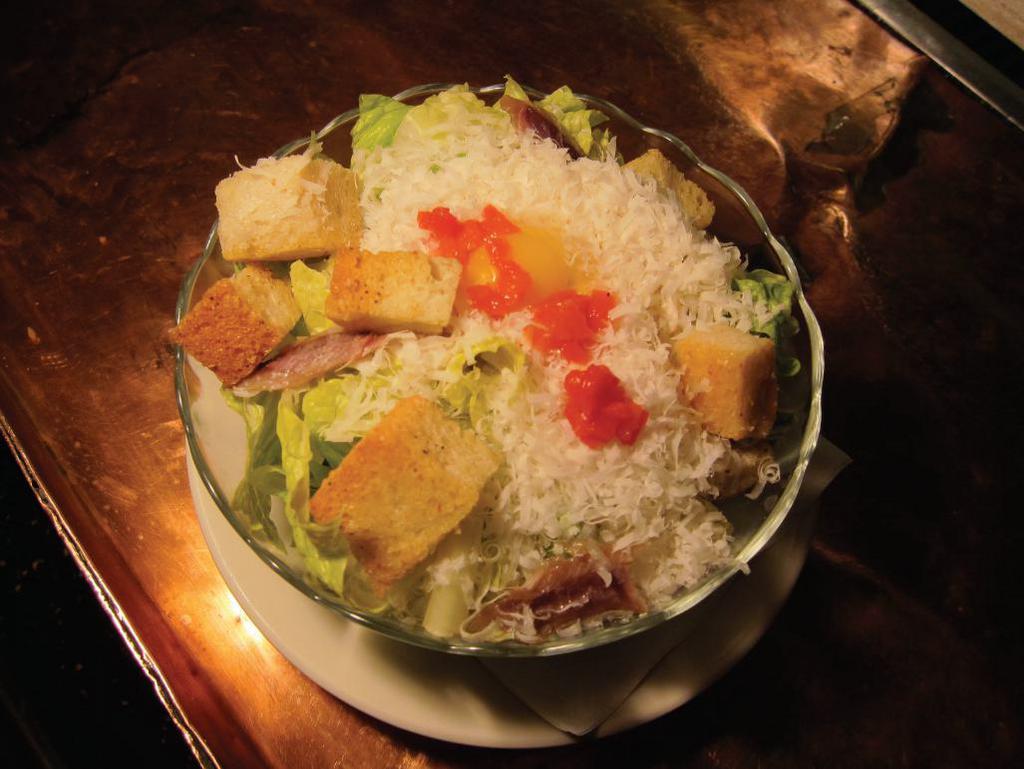 Baby Caesar Salad · Romaine lettuce, Parmesan cheese, anchovies, house-made garlic croutons. The dressing does not contain raw egg, but is made with anchovies.