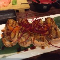 VOLCANO · -CALIFORNIA ROLL WEAPPED WITH SALMON, TOPPED WITH SPICY TUNA, AND BAKED WITH MAYO, SERVED WI...