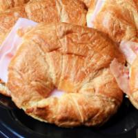 Ham, egg & cheese sandwich · Slice of ham and a slice of American cheese on a house made croissant
