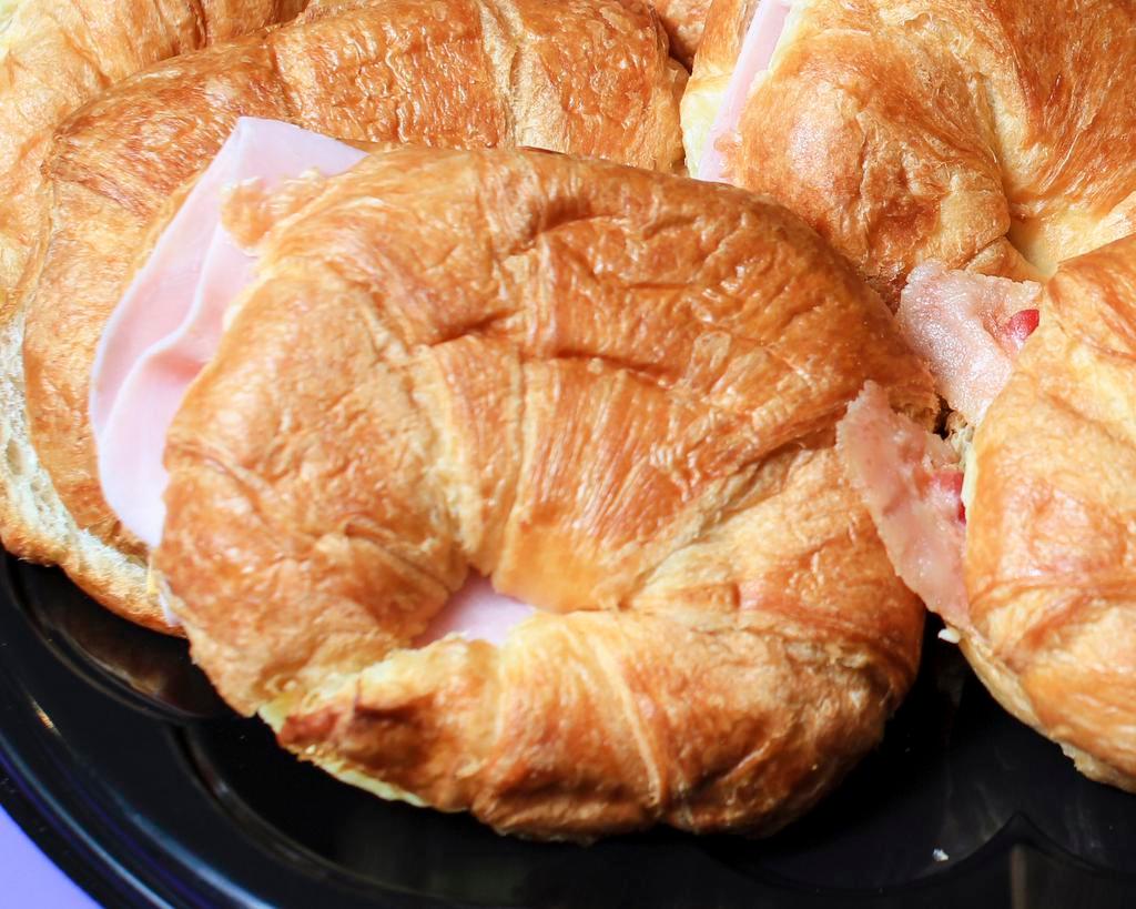 Ham, egg & cheese sandwich · Slice of ham and a slice of American cheese on a house made croissant