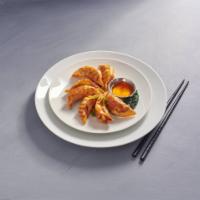 D4. Seven Piece Pot Stickers · Deep fried vegetables and chicken pot stickers served with sweet and sour sauce.