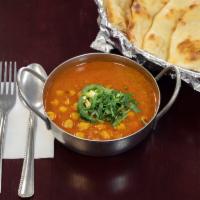 Cholay Bathura · Chick peas cooked with an Indian blend of spices. Served with a bathura (poori). Vegetarian.