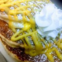 Lemon Ricotta Pancakes · Lemon ricotta pancakes topped with lemon curd, whipped cream and powder sugar