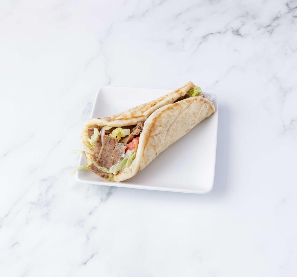 Traditional Gyro · Lettuce, tomatoes, onions and our tzatziki sauce.
