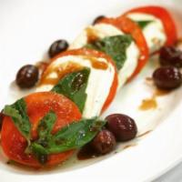 Tomato Caprese · Fresh Buffalo mozzarella served over steak tomatoes, fresh basil with olive oil and balsamic...