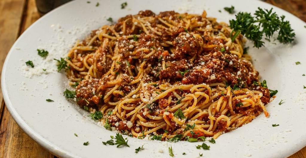 Spaghetti Bolognese Dinner · Spaghetti pasta tossed in our homemade meat sauce. Comes with your choice of tomato basil soup or salad and garlic bread. House or caesar salad