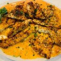Sun-Dried Tomato Ravioli with Grilled Chicken Dinner · Ravioli pasta stuffed with ricotta cheese in creamy sun dried tomato sauce topped off with g...