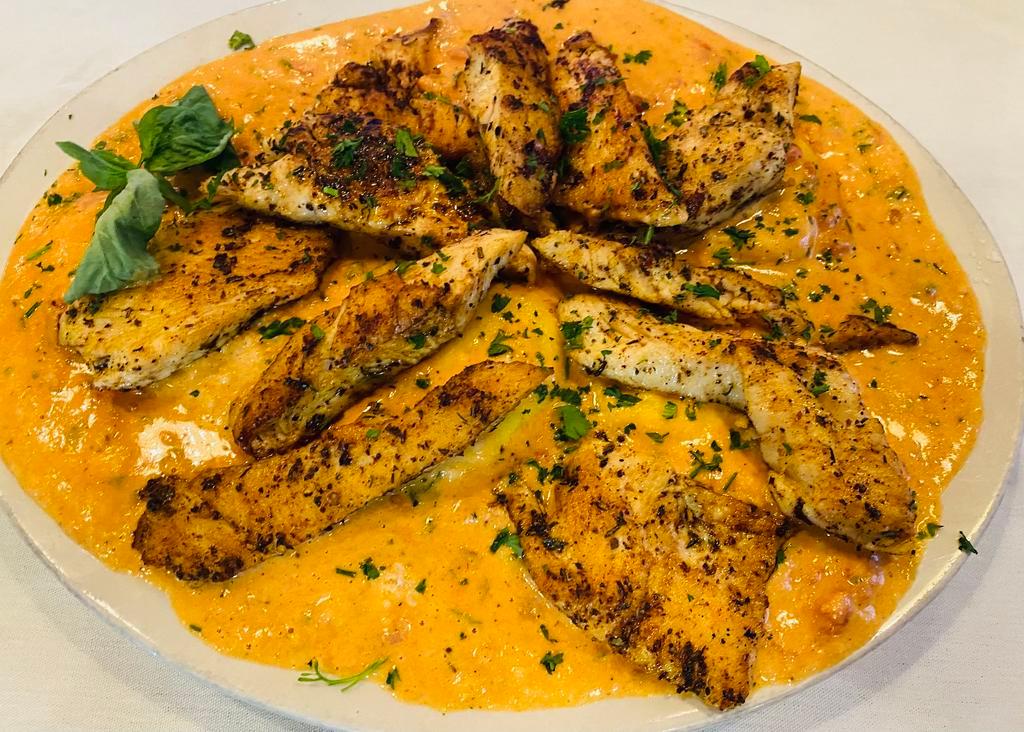 Sun-Dried Tomato Ravioli with Grilled Chicken Dinner · Ravioli pasta stuffed with ricotta cheese in creamy sun dried tomato sauce topped off with grilled chicken. Comes with your choice tomato basil soup or salad and garlic bread.  House or caesar salad