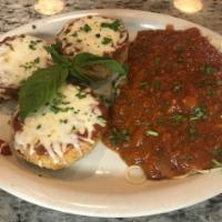 Eggplant Parmigiana Dinner · Lightly breaded eggplant topped off with our homemade marinara and mozzarella served with pa...