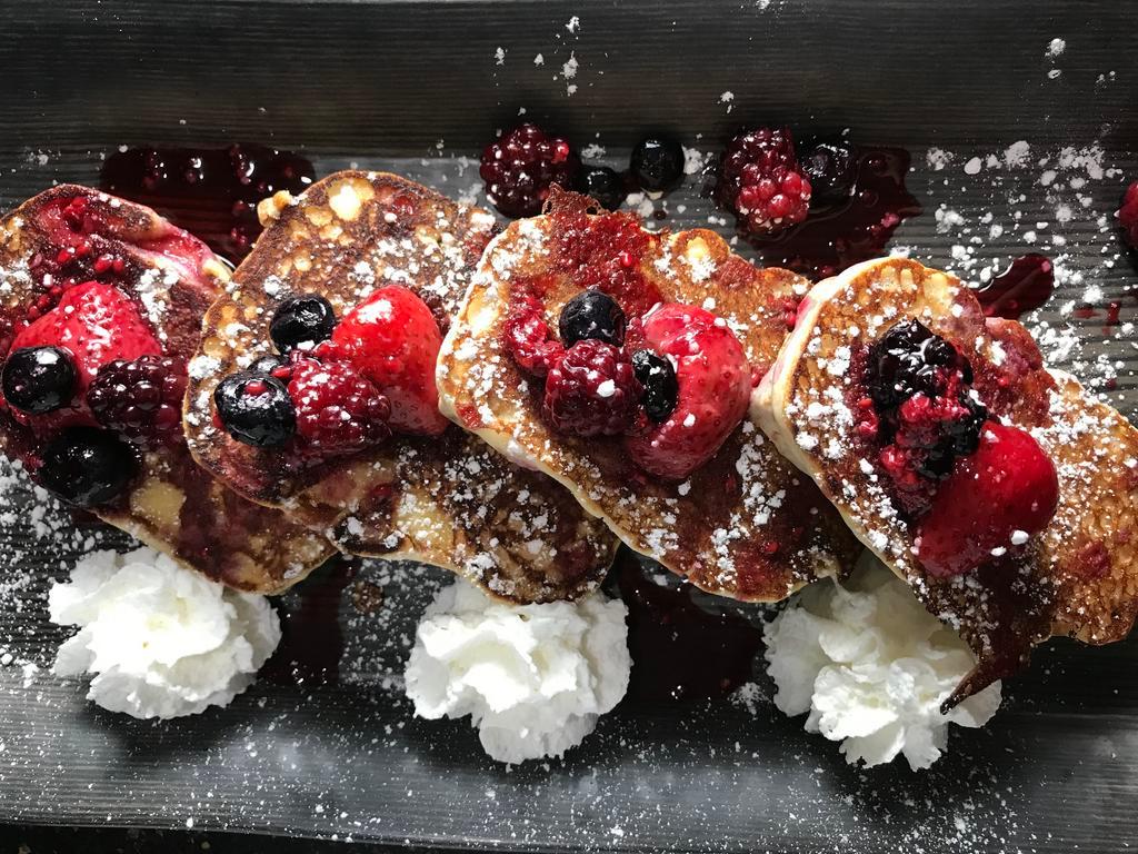 Berry Licious Pound Cake  · Thick slices of pound cake dipped in a cinnamon & sugar egg batter, grilled golden brown and topped with a fresh berry medley, powdered sugar, and vanilla creme.
